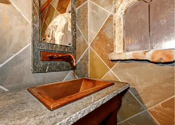 Castle style bathroom with copper sink and faucet